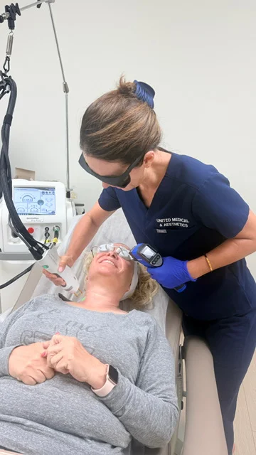 United Medical & Aesthetics staff member performing a laser facial treatment near a client's eye area