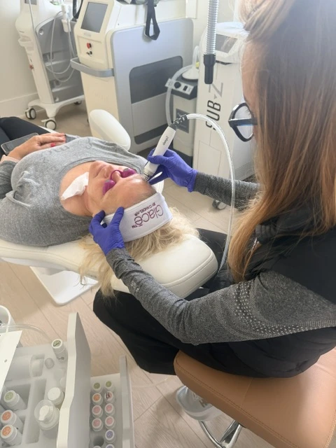 Patient receiving Glacē facial treatment with practitioner using handheld device